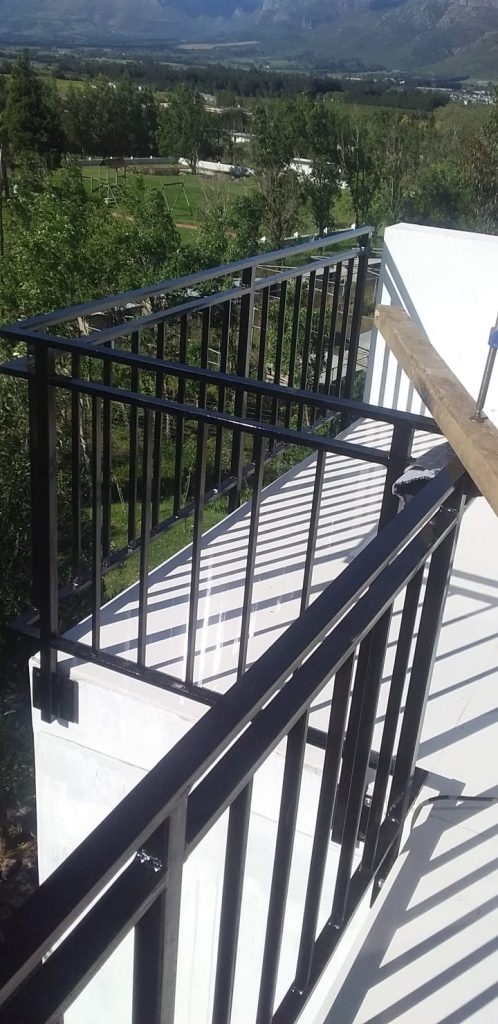 Black steel balcony railing and staircase balustrade overlooking the Cape Winelands