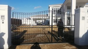 Ornate wrought iron security gate with circular scroll pattern installed at a Cape Town home