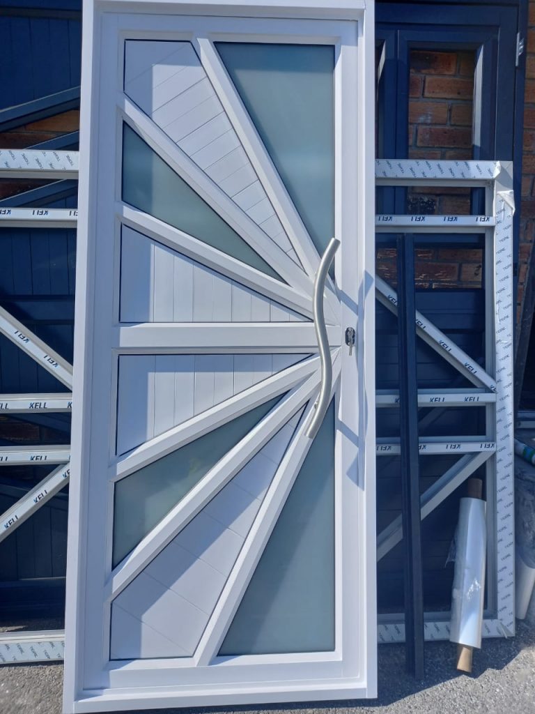 White aluminium security door with sunburst diagonal frame design, custom aluminium fabrication