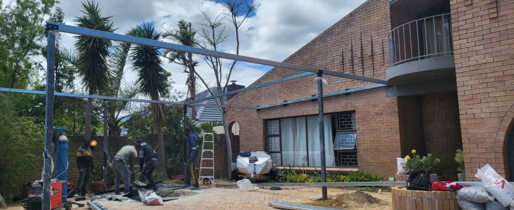 Steel carport frame being erected on-site in Cape Town by Supar Steel welders